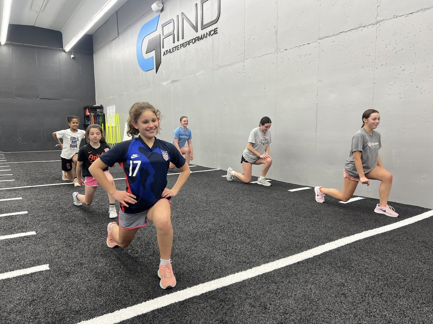 Young athletes training on the turf at Grind