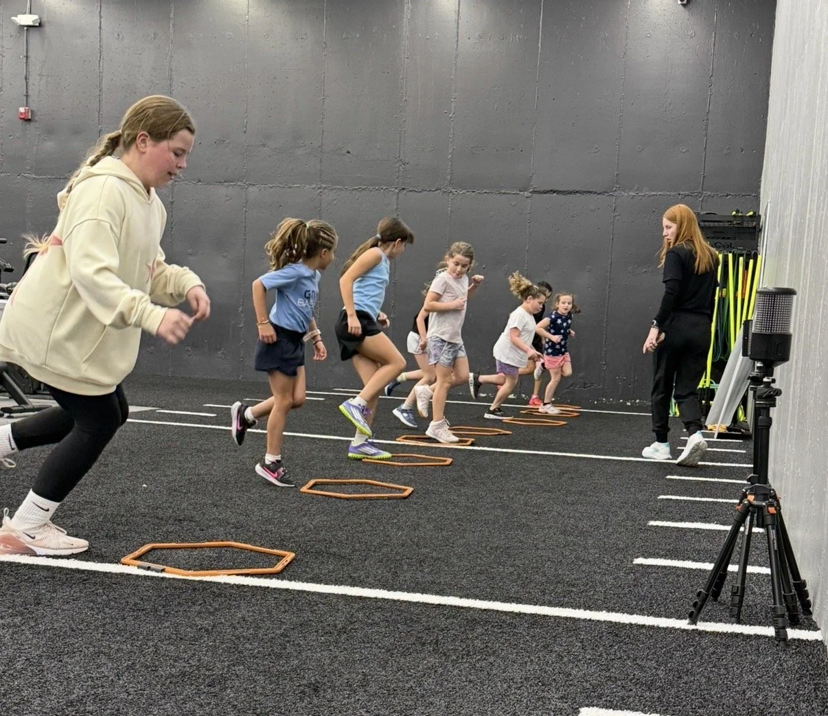 Young athletes doing agility drills at Grind